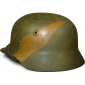 M 40 Heeres or Waffen SS camouflaged helmet.