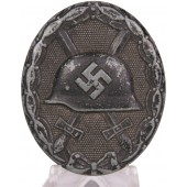 Чёрная степень знака за ранение 1939 ESP. Знак с маркировкой на шлеме