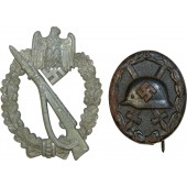 Lote de 2 condecoraciones: insignia de herido negro e insignia de asalto de infantería.
