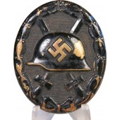 Uncleaned early black wound badge in Messing
