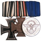 Een medaillebalk met 3 onderscheidingen voor een WOI-veteraan, een politieagent in het 3e Rijk