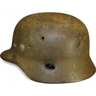 ET 64 marked M 35 war time reissued camouflaged steel helmet with fragmentation damage. Espenlaub militaria