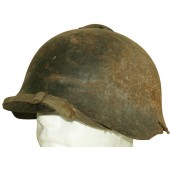 Стальной шлем СШ 36 с пулевым повреждением